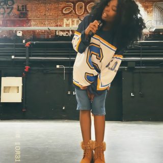 a woman standing on top of a stage holding a microphone in her hand and wearing yellow boots Sza Halloween Iconic Sza Pictures, Sza Costume For Kids, Sza Iconic Outfit, Sza 90s Outfit, dark olive green