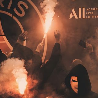 a group of people holding flarers in front of a wall with logos on it Football Halloween Psg Psg Aesthetics, Psg Logo Black Background, Psg Team For Phone, dark olive green