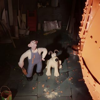 two stuffed animals sitting next to each other on a floor in front of a wall Wallace And Gromit Halloween Background Wallace And Gromit Happy Birthday, Wallace And Gromit Cat, Wallace And Gromit, black