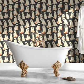 a bath tub sitting next to a wall covered in halloween ghostes Halloween Themed Bathroom dark gray
