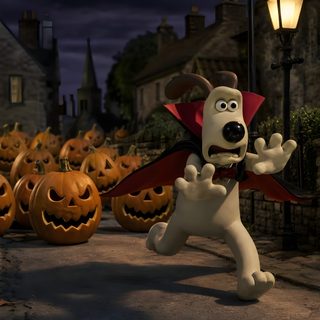 a cartoon dog dressed up as a vampire in front of pumpkins on the street Wallace And Gromit Halloween Background black