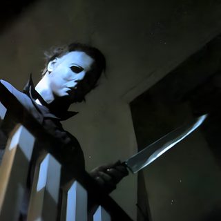 a man holding a knife in his hand while standing next to a stair railing at night Halloween 1978 Michael Myers Michael Myers Aesthetic, Halloween Michael Myers Aesthetic, Michael Myers Lockscreen, black