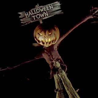 a scarecrow holding a sign that says halloween town Halloween Town Movie This Is Halloween, Halloween Movie Lockscreen, Halloween Aesthetic Nightmare Before Christmas, black