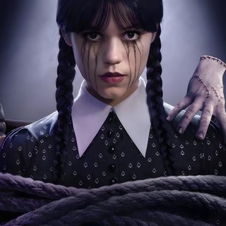 a woman with long braids in her hair and wearing a black shirt, standing next to a rope Wednesday Addams Halloween Uncle Fester, Madame Doubtfire, Riki Lindhome, The Addams Family, black