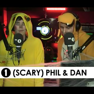 two people in yellow costumes standing next to each other with microphones on their heads Dan And Phil Halloween 2009 Dan And Phil Halloween Baking, Dan Howell Halloween Costume, Dan And Phil Bbc Radio 1, dark slate gray