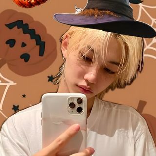 a person holding a cell phone in front of a wall with halloween decorations Felix Halloween Normal, Halloween, Kids, peru