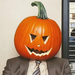 a man wearing a suit and tie with a pumpkin on his head in front of him Dwight Halloween Dwight Halloween, The Office Halloween Michael, Dwight Pumpkin Head, indian red