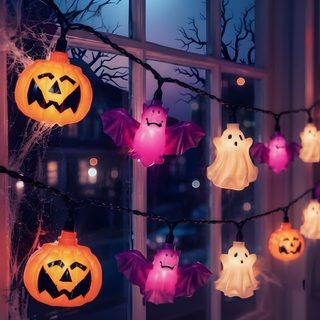 halloween decorations hanging from a window at night Halloween Home dark slate gray