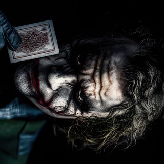 a man with long hair wearing a clown mask and holding a card in his hand Juvea Halloween 4k Joker Laptop, Dark Knight, Heath Ledger Joker Quotes, Wolverine Comic Art, 2k, black