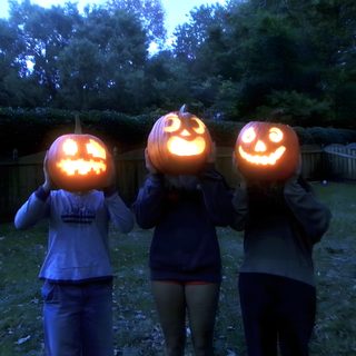 three people holding pumpkins with faces carved into them 2000s Halloween Aesthetic Catty Noir, Halloween Pictures With Friends, Friend Pumpkin Head Photoshoot, dark slate gray