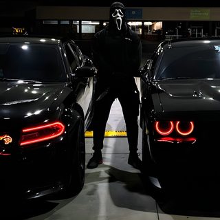 a man standing next to two black cars in a parking lot with the lights on Halloween Hellcat Hellcat Ghost, Black Ghost Hellcat, Hellcat Black Ghost, Demon Hellcat,
