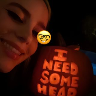 a woman holding up a pumpkin with the words i need some head carved on it Billie Eilish Halloween Billie Eilish Pumpkin Painting, Billie Eilish Pumpkin Carving Ideas, Billie Eilish Pumpkin, black