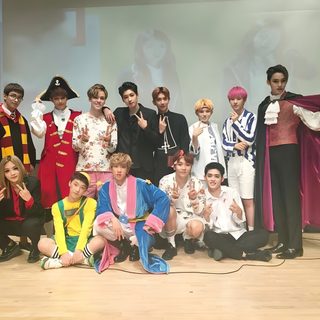 a group of young men standing on top of a wooden floor next to each other Seventeen Halloween Seungkwan Halloween, Seventeen Halloween, Seventeen Costume Ideas, dark gray