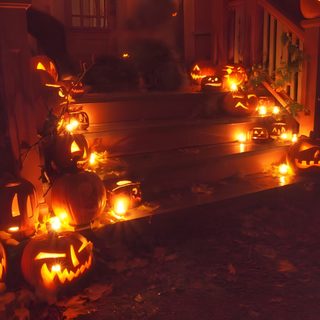 halloween pumpkins lit up on the steps in front of a house with carved faces Halloween Medium Widget Halloween Watch Your Step, Halloween Watch Your Step Ideas, Watch Your Step Halloween, maroon