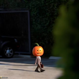 a person walking down the street with a pumpkin on their head Dwight Halloween Dwight Halloween Gif, Dwight Halloween, Dwight Pumpkin Meme, black