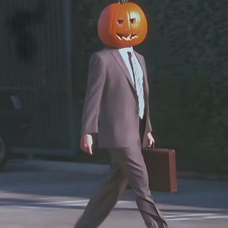 a man in a suit and tie with a pumpkin on his head walking down the street Dwight Halloween dark slate gray