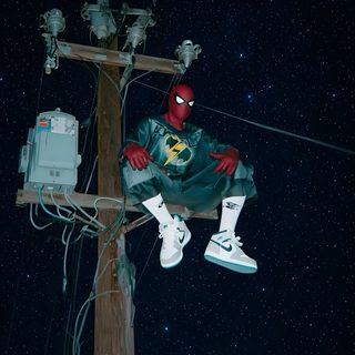 a spider man sitting on top of a telephone pole Halloween Spiderman Spiderman, black