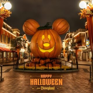 a mickey mouse pumpkin is on display in the middle of a street with lights around it Magic Kingdom Halloween Halloween, Disney Photos, Disneyland California, Disneyland Resort, saddle brown