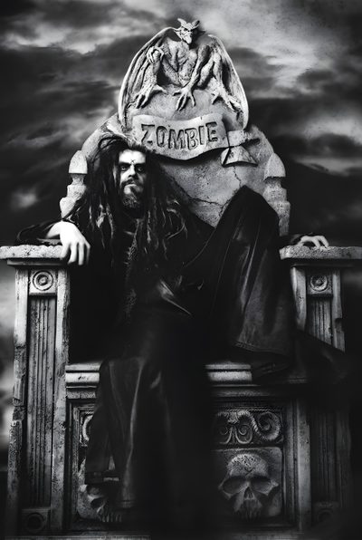 a black and white photo of a man with long hair sitting on a bench in front of a statue Halloween Rob Zombie Rob Zombie Aesthetic Pfp, Rob Zombie Aesthetic, Rob Zombie Photoshoot, dark slate gray