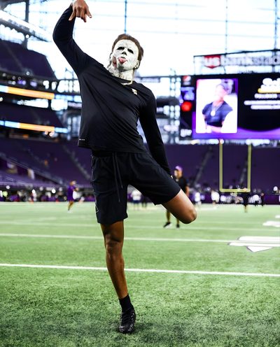 a man wearing a mask and black shorts standing on top of a field with his hands in the air Justin Jefferson Halloween Justin Jefferson Pfp 4k, Justin Jefferson Halloween, Jjetas, dark sea green