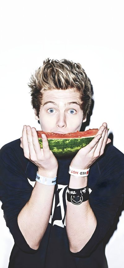 a young man holding a piece of watermelon in front of his face with both hands 5sos Halloween 5sos Photoshoot, 5sos Luke, Luke Roberts, Eating Watermelon, Android, antique white