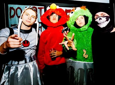 three people dressed up in costumes posing for a photo with one person wearing a costume 5sos Halloween 5sos Halloween, 5sos Fall Aesthetic, 5sos Playlist Cover, 5sos Halloween Costumes, black