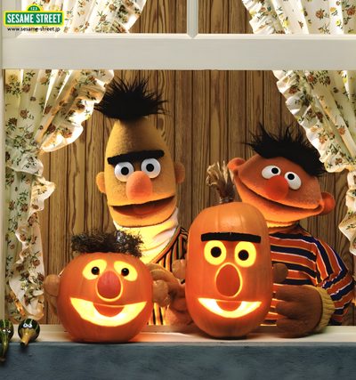 sesame and bert pumpkins on display in front of a window with the faces carved into them Sesame Street Halloween Sesame Street Pumpkin Carving, Sesame Street Pumpkins, Bert Ernie Pumpkins, sienna