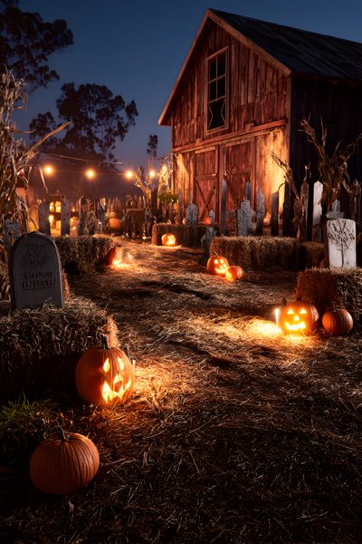 pumpkins lit up in front of a barn at night with lights on the ground Halloween Farm Halloween Outdoor Theme Ideas, Farm Halloween Party, Haunted Farm Halloween Decor, black