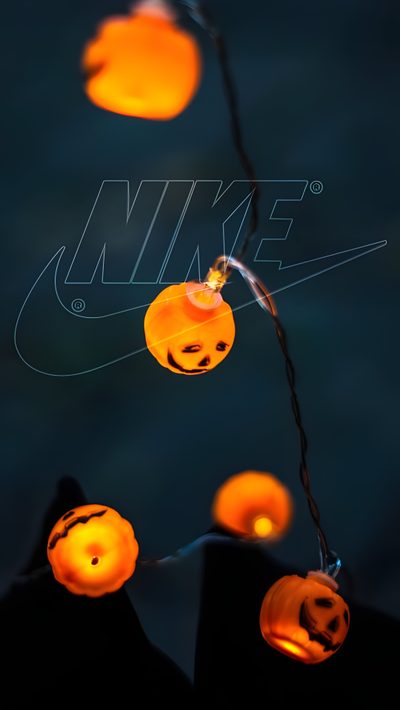 halloween pumpkin lights hanging from a wire in the dark Halloween Nike Neon Halloween Iphone, Halloween Nike, Fall Nike, Nike Pumpkin Carving Ideas, black