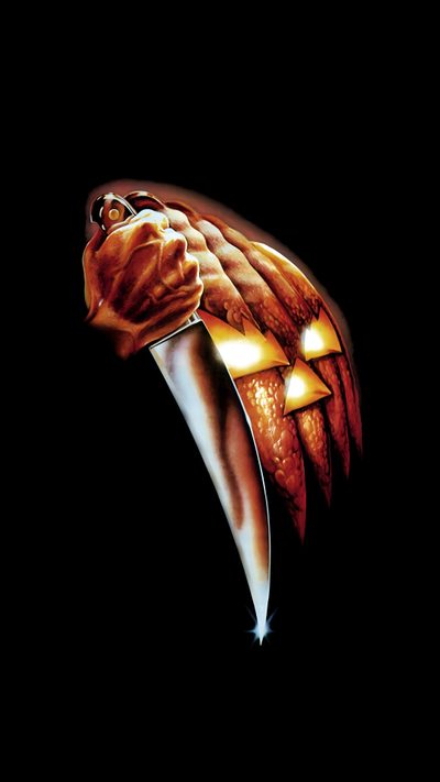 a scary pumpkin shaped like a head with glowing eyes on it's face and hands Halloween Movie Iphone Halloween Ends, Halloween Movie, Halloween 4 Poster, black