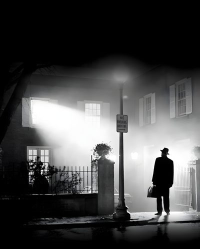 a man standing in front of a building on a foggy street at night with a lamp post Exorcist Halloween Exorcist Movie Halloween, Exorcist Black And White, The Exorcist Black And White,