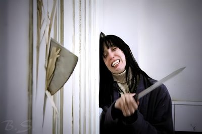 a woman holding a pair of scissors in her hand The Shining Laptop Halloween Dark Thriller Atmosphere, Halloween Costume Inspiration, Horror Movie Scene, gray