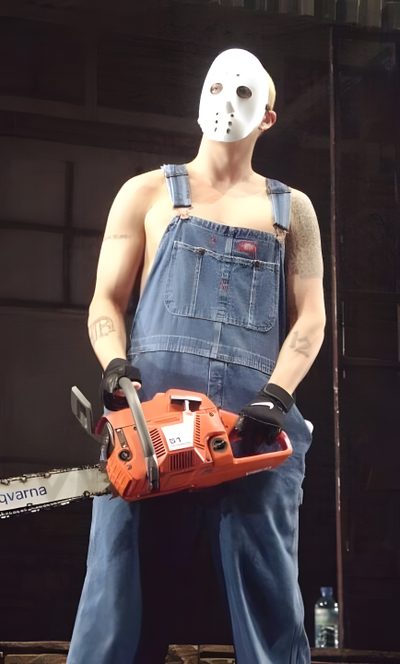 a man in overalls holding a chainsaw with a mask on it's face Eminem Halloween Slim Shady Costume Ideas, The Real Slim Shady Costume, Slim Shady Jason Mask, dark slate gray