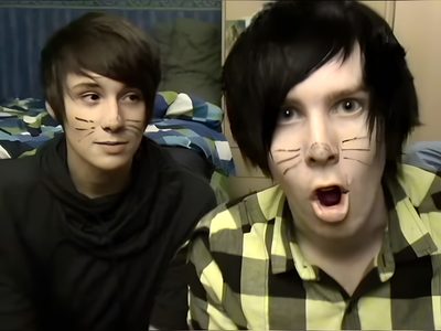 two young men with their faces painted to look like cats Dan And Phil Halloween 2009 Dan And Phil Cat Makeup, Dan And Phil Halloween, Dan And Phil Photobooth, dark slate gray