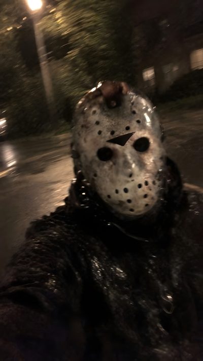 a person wearing a mask and chains on the street at night with trees in the background Jason Halloween Jason Voorhees Scary, Jason Universe, Jason Walpaper, Jason Voorhees Hq, black