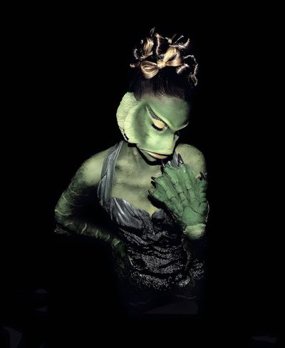 a woman with green makeup and hands on her face, in front of a black background Ariana Grande Halloween Ariana Halloween Costume, Ariana Grande Twilight Zone Costume, Ariana Grande Halloween Pfp, black