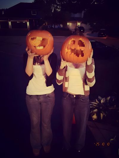 two women holding pumpkins with faces carved into them Best Friend Halloween Halloween Spirit, Fall Esthetic, Fall 2026 Aesthetic, Fall Aesthetic Spooky, black