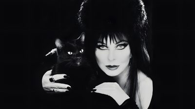 a woman holding a black cat in her arms Elvira Halloween Photo Of Elvira, Elvira Album Cover, Elvira Character, Goth Laptop, black