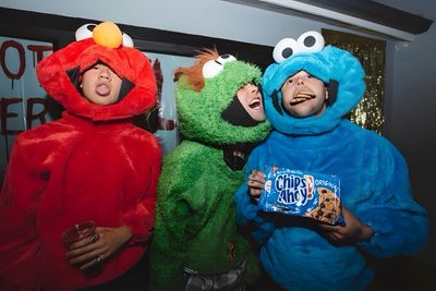 three people dressed in sesame street characters posing for a photo with one holding a candy bar 5sos Halloween 5sos Christmas, Ashton And Drake, 5sos Halloween, dark slate gray