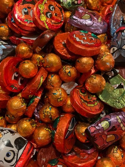 there are many candy candies in the pile together with faces painted on each one Halloween Candy Old Halloween Candy, British Halloween, Retro Halloween Aesthetic, saddle brown