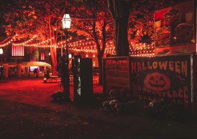 an outdoor area with lights and decorations on the trees Salem Halloween Aesthetic Halloween Theater, Salem During Fall, Salem Fall Aesthetic, dark slate gray