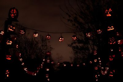 many pumpkins are lit up in the night sky and on wires, with trees behind them Halloweencore Halloween Sky Aesthetic, Halloween Aesthetic Computer, Halloween Header, black