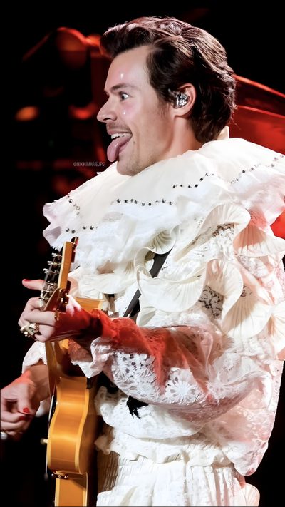 a man in a white dress holding a guitar and singing into a microphone with his mouth open Harry Styles Happy Halloween Iphone Harryween Night 2, Harryween, Nikki Marie Twitter, indian red