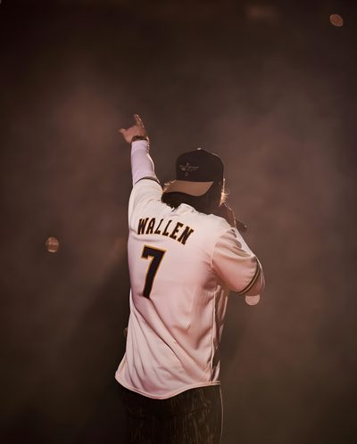 a baseball player holding his arm up in the air while wearing a white shirt and black pants Morgan Wallen Halloween Morgan Wallen One Thing At A Time, Morgan Wallen Pictures For Wall Collage, Morgan Wallen Lyrics 98 Braves, dark slate gray