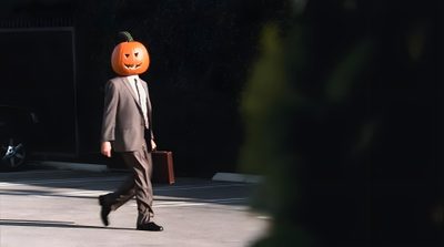 a man in a suit walks down the street with a pumpkin mask on his head Dwight Halloween The Office Dwight, Dunder Mifflin, Pumpkin Carving, Halloween, Outdoor Decor, black