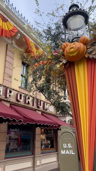 an orange and yellow awning on the side of a building next to a mailbox Disneyland Halloween Aesthetic Vacation Planner, Disneyland Fall Decorations, Disney Merch, sienna