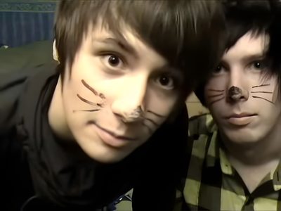 two young men with their faces painted to look like cats Dan And Phil Halloween 2009 Dan And Phil Young, Dan And Phil Catboy, Dan And Phil Cat Ears, dark slate gray
