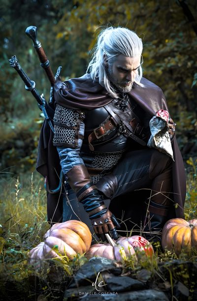 a man dressed up as the witch sitting on top of pumpkins in a field Witcher Geralt Halloween Wild Hunt Heathcliff Cosplay, Witcher Costume Men, Geralt Cosplay, dark slate gray