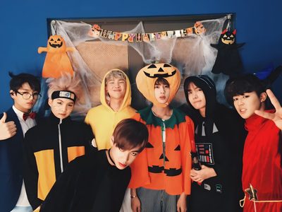 a group of young men standing next to each other in front of a blue wall Bts Halloween Laptop Fall Bts, Bts Thanksgiving, Bts Pumpkin Painting, Bt21 Halloween, dark slate gray