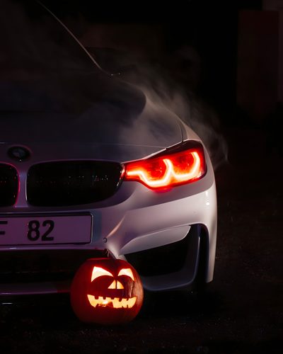 a car with a pumpkin carved into the trunk and headlight on it's side Bmw Halloween Bmw Scary, Bmw Horror, Bmw Pumpkin Carving, Bmw Fall, Bmw Fall Background, Bmw Ghost, black